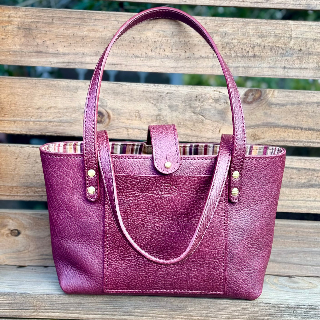 The Megan in Plum on pallet backrground