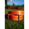 Fairway Signature Belt in premium Italian leather, vibrant orange color with handcrafted stitching and a classic buckle.